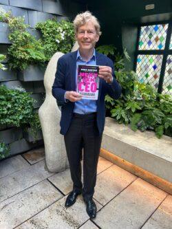 Sir Richard Halpin holding a copy of Mike Soutar's book Next Gen CEO